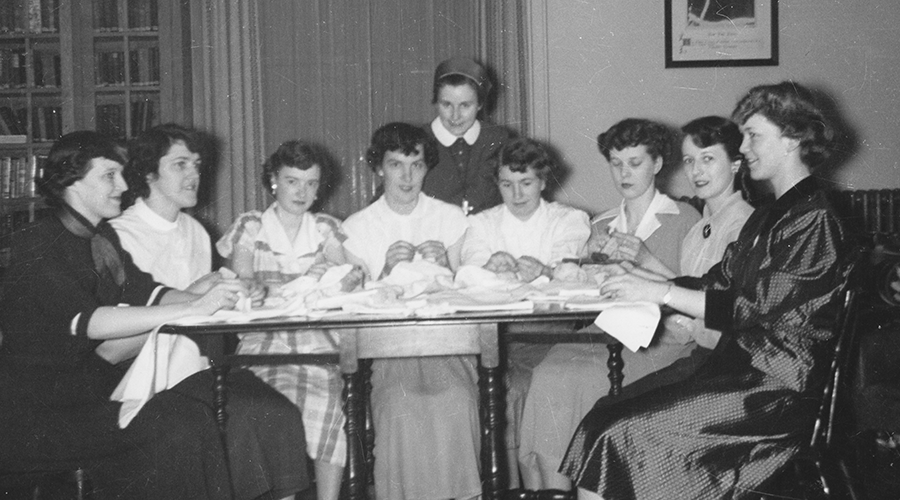 Sister Mossey sews with residents
